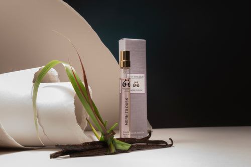 10ml option. Small perfume bottle with packaging on a white surface with a dark background