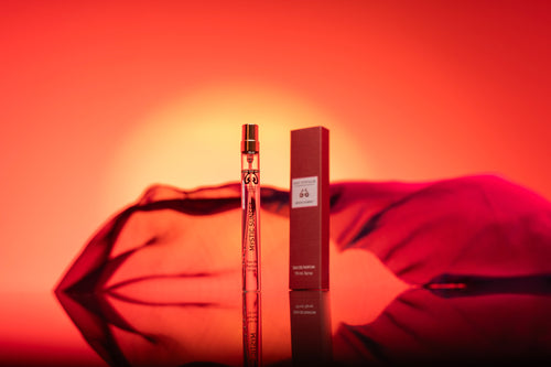 10ml option. Perfume bottle and packaging on a reflective surface with a red background